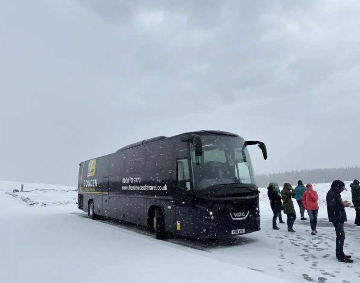 Coach prepared for evening event transport in Birmingham during winter